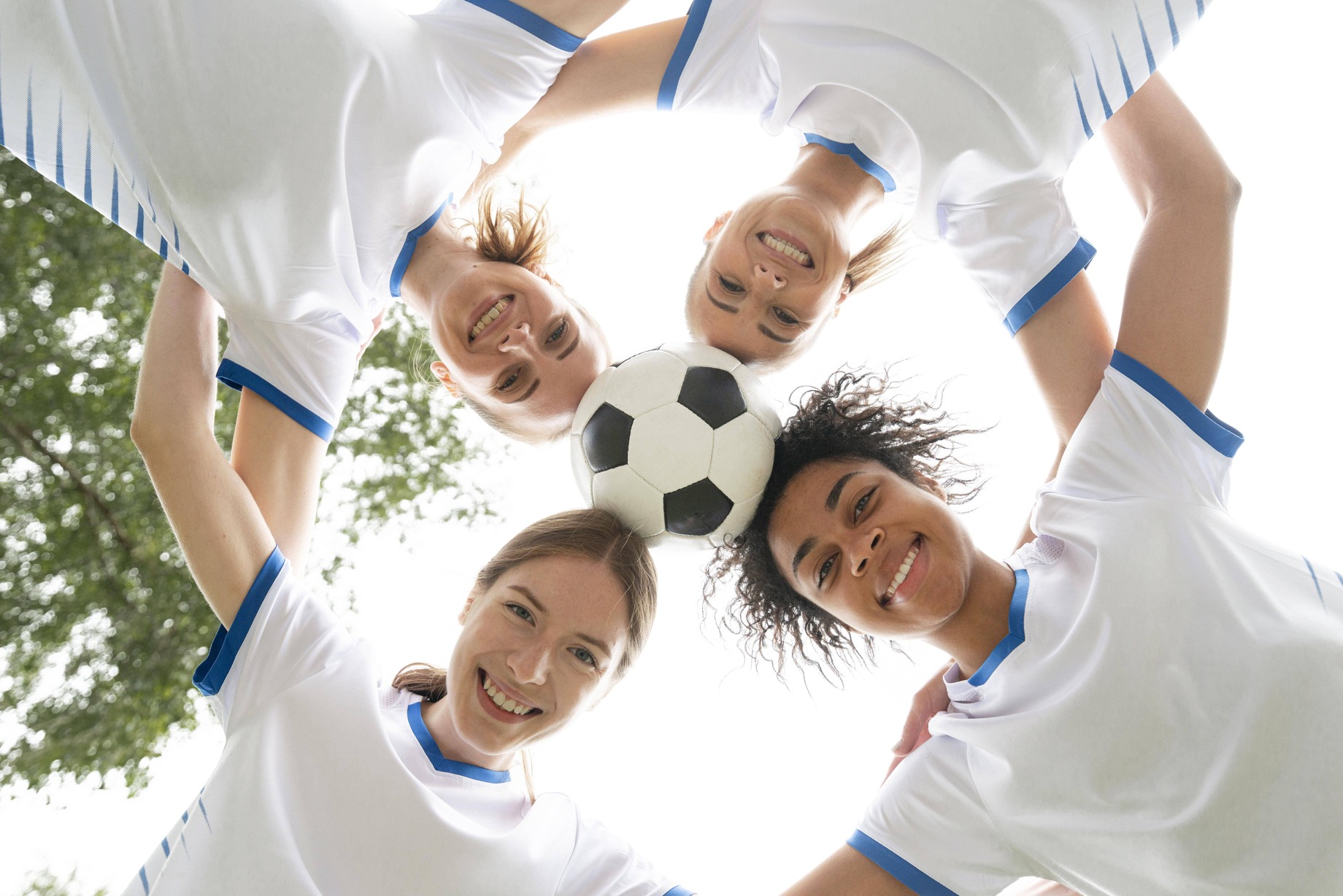 bottom-view-smiley-women-holding-ball